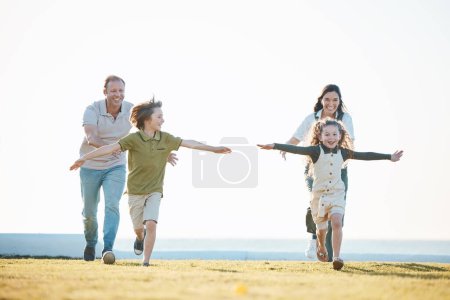 Photo for Running, parents and children in nature by ocean for bonding, relationship and relax together. Family, travel and happy mother, father and kids on holiday, summer vacation and playing for adventure. - Royalty Free Image