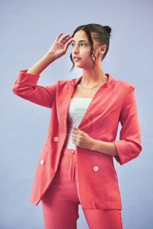 Photo for Fashion, suit and woman in studio thinking, confidence and body in beauty aesthetic. Makeup, style and influencer girl in designer clothes, trendy promo or confident model standing on blue background. - Royalty Free Image