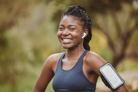 Téléchargez les photos : Fitness, sourire et portrait de femme noire à l'exercice en plein air, à l'entraînement ou à l'entraînement dans une forêt pour le bien-être. Heureux, confiant et jeune prêt et à l'écoute de musique, audio ou podcast. - en image libre de droit