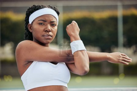 Photo for Sports, portrait and woman tennis player doing warm up for practice to play match at stadium. Fitness, serious and African female athlete with stretching exercise for training on court for tournament. - Royalty Free Image