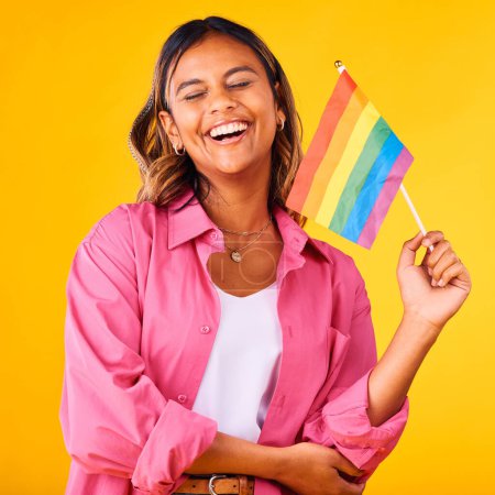 Photo for Happy woman, pride and flag with rainbow and LGBTQ community in studio, equality and celebration on yellow background. Freedom to love, support with lesbian or ally, gen z student with gay identity. - Royalty Free Image