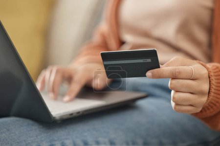 Photo for Closeup, woman and laptop with credit card, online shopping and transaction in a lounge. Person, home and girl on a sofa, pc or digital app with payment, banking and budget with fintech or investment. - Royalty Free Image