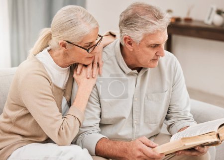 Photo for Bible study, faith and senior couple with a book in a living room relax, reading and bond at home. God, Worship and retired elderly people with scripture, guidance or gospel, love and Jesus praise. - Royalty Free Image