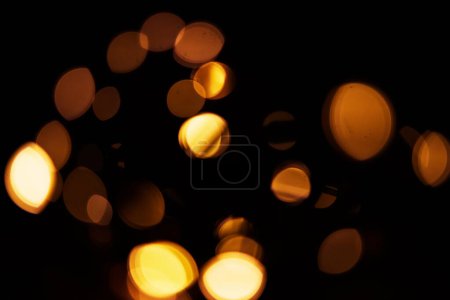 Téléchargez les photos : Or, bokeh et lumière dans un studio avec un fond sombre pour la célébration, l'événement ou la fête. Mockup, scintillement et jaune pour lueur, magie ou brillance pour une décoration festive sur fond noir avec maquette - en image libre de droit