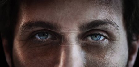 Photo for Eyes, vision and a man closeup in studio on a dark background for mental health or depression. PTSD, trauma or awareness and pupil portrait of a person looking serious about a memory and idea. - Royalty Free Image