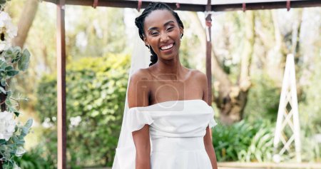 Photo for Wedding, portrait of bride with smile in gazebo with garden for celebration of love, future and commitment. Outdoor marriage, flowers and plants, happy black woman in nature, sunshine and park event - Royalty Free Image