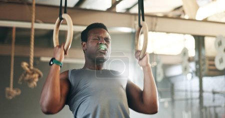 Photo for Sports, gymnastics and black man doing pull up exercise for arm muscle training or workout in gym. Fitness, bodybuilding and African male athlete doing an intense strength challenge in health center - Royalty Free Image