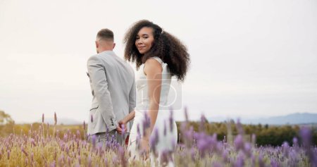 Photo for Wedding, nature and happy couple walking garden with love, celebration and excited future together. Field, man and woman at luxury marriage reception with flowers, smile and commitment holding hands - Royalty Free Image