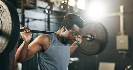 Photo for Black man at gym, weight lifting and barbell for muscle building endurance, strong body or balance power in fitness. Commitment, motivation and bodybuilder in workout challenge in health and wellness. - Royalty Free Image