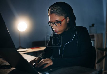 Photo for Hacker, woman in dark room with laptop and cyber crime, phishing and information technology with database or server. Cybersecurity, programming and criminal with pc, ransomware and firewall breach. - Royalty Free Image
