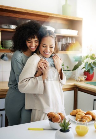 Photo for Breakfast, lgbtq and couple hug in morning in home eating together for bonding, love and care. Embrace, lesbian and happy women with food for healthy relationship, nutrition and meal for romance. - Royalty Free Image