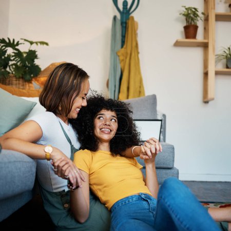 Photo for Lesbian, couple and relax on couch in communication at home for support, trust and partnership. Happy lgbt woman, living room or smile for identity or equality love in house, commitment or together. - Royalty Free Image