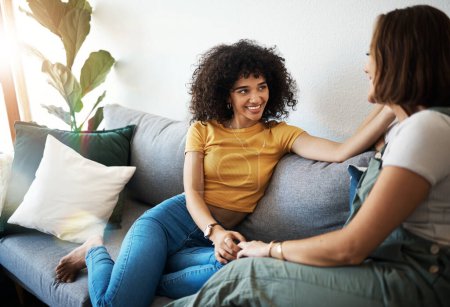 Photo for Discussion, love and lesbian couple relaxing on a sofa in the living room talking and bonding. Happy, conversation and young interracial lgbtq women speaking and resting together in lounge at home. - Royalty Free Image