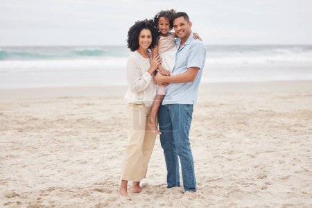 Photo for Hug, portrait and a family at the beach for a vacation, travel or walking by the ocean. Happy, care and a young mother, father and girl kid at the sea for a holiday, bonding or together in summer. - Royalty Free Image