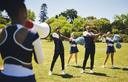 Photo for Cheerleading team, coach and megaphone for practice, stretching and sports field for dancing, cheering and support. Training, warm up and outdoor for exercise together, competition and energy. - Royalty Free Image