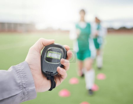 Photo for Hands, coach or team with stop watch on field to monitor time, fitness training or exercise progress. Hockey, performance blur or fast sports athlete with timer to check running workout or wellness. - Royalty Free Image