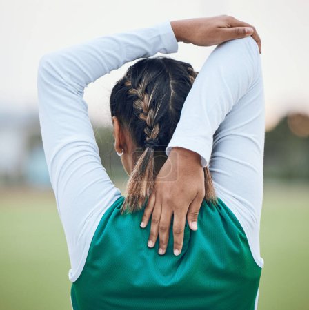 Photo for Back, stretching and a woman hockey player getting ready for the start of a game or competition outdoor. Sports, fitness and warm up with an athlete on a field for a training workout or practice. - Royalty Free Image
