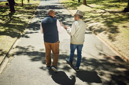 Photo for Senior, friends walking and talking in park, nature and outdoor in retirement with support and communication. Elderly, men and behind people on path in New York with conversation and community. - Royalty Free Image