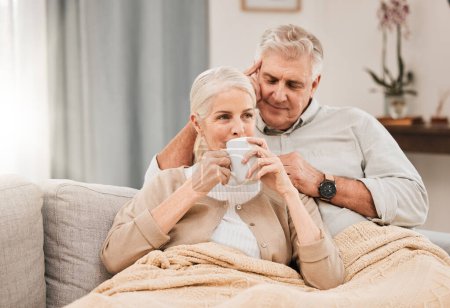 Photo for Old couple, hug and relax on couch with coffee, love and support, bonding while at home with trust and comfort. People have tea together, marriage or partner with retirement, calm and peace of mind. - Royalty Free Image