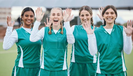 Photo for Sports, women and team with hands for hello or wave with happiness on field outdoor for teamwork, training or workout. Football, group and girls with diversity and hi in nature for game or exercise. - Royalty Free Image