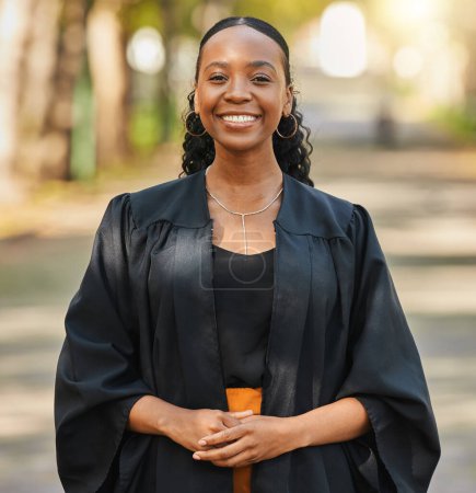 Photo for Portrait, graduate and happy black woman at university at campus outdoor. Face, graduation and smile of confident African student at college for education achievement, learning and success in Nigeria. - Royalty Free Image