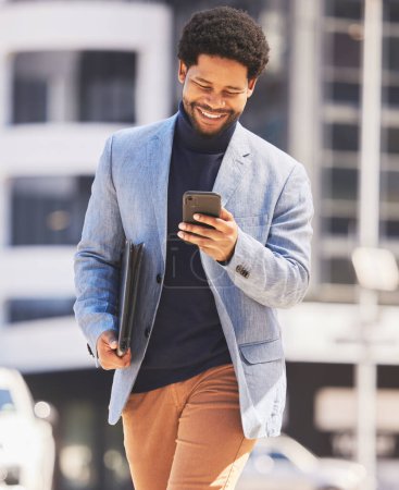 Photo for Business, city and black man with a smartphone, typing and walking with a smile, network and connection. African person, consultant and entrepreneur outdoor, cellphone and social media with contact. - Royalty Free Image