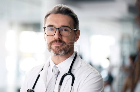 Photo for Serious doctor, portrait and man with glasses in hospital for health, wellness or career in medicine. Face, medical professional and confident surgeon, expert therapist or mature physician in Canada. - Royalty Free Image