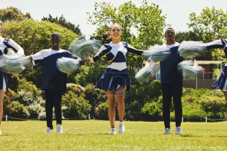 Photo for Portrait, sports and a cheerleader group of young people outdoor for a training routine or event. Support, team and diversity with a happy cheer squad on a field together for motivation with pom poms. - Royalty Free Image