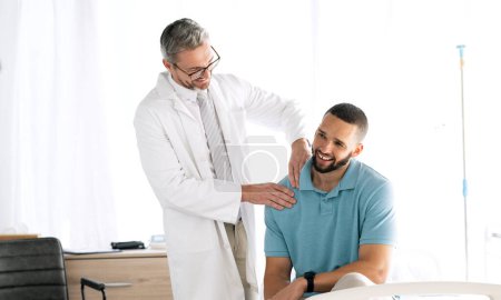 Photo for Doctor, men and consultation with conversation, healthcare and appointment with injury, muscle tension and medicare. Patient in an office, medical professional and speaking with checkup and wellness. - Royalty Free Image