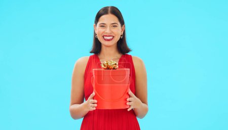 Photo for Birthday present, excited and woman in portrait in studio, celebration and giveaway isolated on blue background. Happiness, smile and winning with gift box, party with reward or bonus prize. - Royalty Free Image