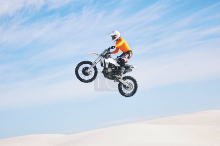 Photo for Motorcycle, jump and man in the air with blue sky, mock up and stunt in sports with fearless person in danger with freedom. Motorbike, jumping and athlete training for challenge or competition. - Royalty Free Image