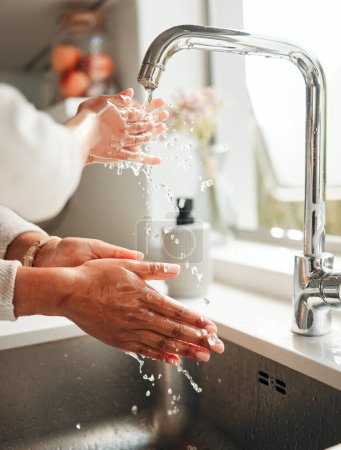 Photo for Hygiene, water and washing hands in a kitchen basin for health, cleaning and fresh before cooking. Morning, sustainability and a person with liquid for home sanitation, purity and routine in a sink. - Royalty Free Image