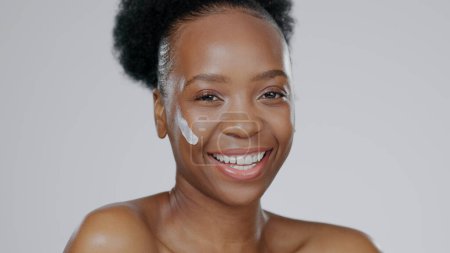 Photo for Black woman, face and cream with beauty, skincare and healthy skin for portrait, moisturizer and blue studio background. Happy, female and sunscreen for dermatology, cosmetology and luxury product. - Royalty Free Image