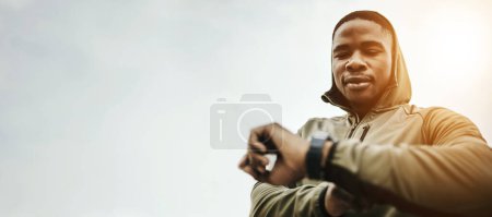 Photo for Black man, smart watch and monitor for fitness, training or exercise schedule with bokeh for personal trainer. Athlete, person and stopwatch or timer for performance update or results for wellness. - Royalty Free Image