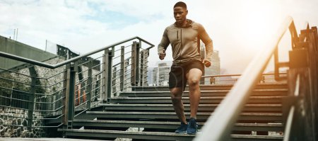 Photo for Fitness, city and black man running on steps outdoor, exercise and training healthy body in the morning. Sports, cardio and African athlete on stairs for endurance workout, energy or jog for wellness. - Royalty Free Image