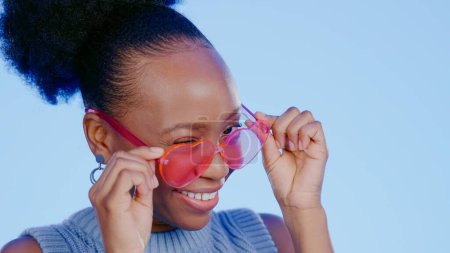 Photo for Fun, sunglasses and smile, black woman in studio with cool, trendy summer fashion and creative mockup. Happiness, luxury eyewear and excited model with designer frame on blue background for eye care - Royalty Free Image
