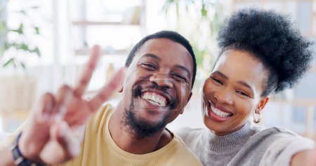 Photo for African couple, selfie and home with peace sign, smile or romance on blog, love or bonding with emoji. Black woman, man and photography for portrait, profile picture and icon on social media in house. - Royalty Free Image