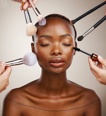 Photo for Makeup, brushes and black woman with cosmetics, skincare and dermatology on grey studio background. African person, wellness or model with tools, grooming and treatment with luxury or shine with glow. - Royalty Free Image