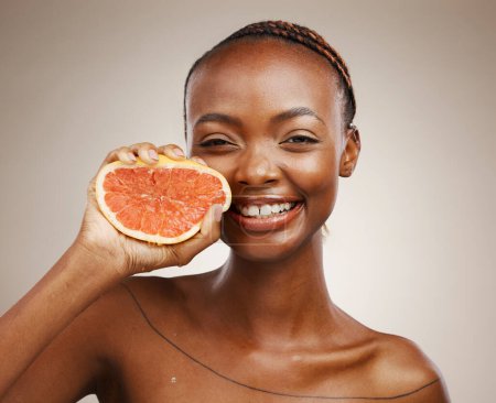 Photo for Black woman, skincare and smile with grapefruit, beauty and cosmetics for healthy skin, vitamin c and facial. Portrait, wellness and glow for dermatology, natural and vegan with citrus, clean or face. - Royalty Free Image