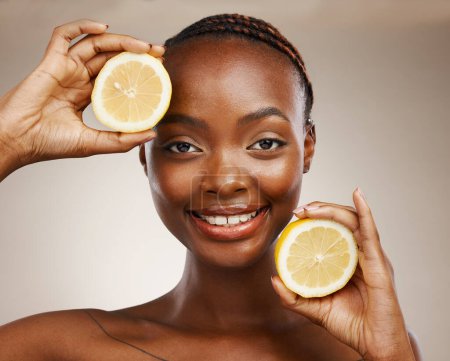 Foto de Mujer negra, frutas de limón y retrato de belleza en estudio para vitamina C, cosméticos veganos y faciales sobre fondo marrón. Cara de modelo feliz, nutrición cítrica y sostenibilidad para el cuidado natural de la piel. - Imagen libre de derechos