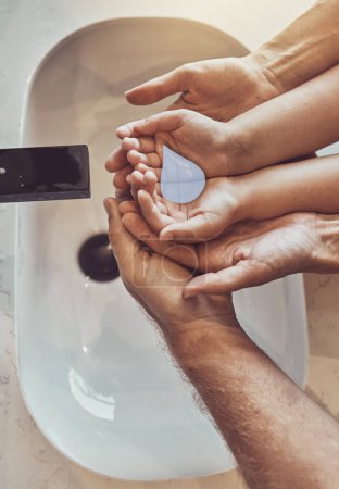 Photo for Bathroom, family and cleaning hands with water emoji from above, help and learning healthy hygiene together. Washing dirt, germs or bacteria, parents and kid in home for wellness, safety or care - Royalty Free Image