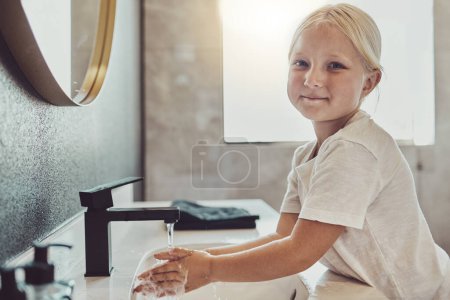 Photo for Bathroom, water and portrait of child washing hands with soap, foam and healthy hygiene. Cleaning dirt, germs and bacteria on fingers, happy girl in home for morning wellness, safety and skin care - Royalty Free Image