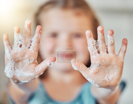 Téléchargez les photos : Savon, se laver les mains et enfant avec de la mousse pour le nettoyage, l'hygiène et le bien-être dans la salle de bain à la maison. Santé, développement de l'enfant et des paumes de la jeune fille avec de l'eau pour la protection des germes, virus et bactéries. - en image libre de droit