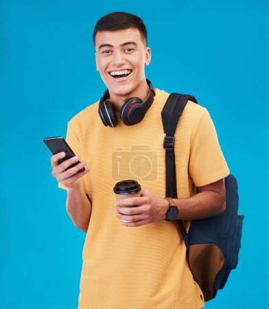Photo for Student, man and smile with phone, coffee and portrait in studio by blue background. Male, ready and portrait for university, scholarship and education, smartphone and online registration on web. - Royalty Free Image