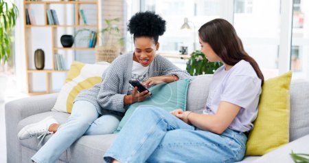 Photo for Cellphone, conversation and girl friends on sofa talking, bonding and networking on social media or mobile app. Happy, discussion and young women scroll on a phone in living room of modern apartment - Royalty Free Image