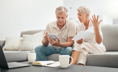 Photo for Frustrated senior couple, documents and financial crisis on living room sofa in debt, expenses or bills at home. Mature man and woman checking finance, paperwork or budget with calculator for invoice. - Royalty Free Image
