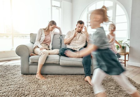 Photo for Family, adhd children and parents headache, stress and anxiety for autism management, energy fatigue or home noise. Tired mother and father on sofa with chaos and hyper or fast, excited kids running. - Royalty Free Image