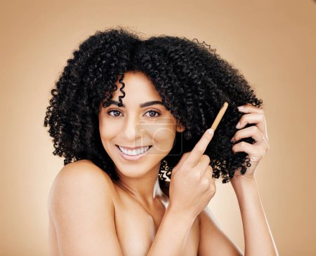 Photo for Afro, hair and brush with portrait of woman in studio for beauty, natural growth or coil texture on brown background. Happy model, curly haircare or comb tools of healthy treatment, aesthetic or care. - Royalty Free Image