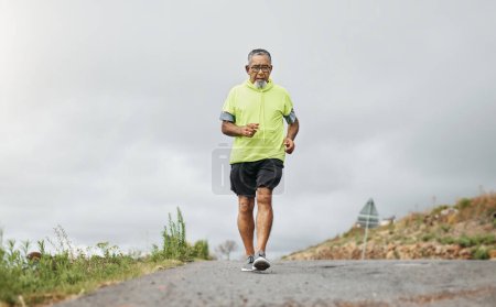 Photo for Senior man, running and road in nature, countryside or forest with exercise for marathon, cardio and health mockup. Fitness, training and person walking on path in workout, sport or run in retirement. - Royalty Free Image