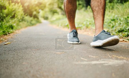 Photo for Man, legs and fitness on road for hiking, workout or walking in outdoor exercise or wellness in nature. Closeup of male person, shoes or feet on path for trekking, training or cardio on asphalt. - Royalty Free Image